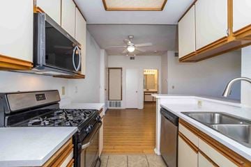North Hollywood apartment for rent - A kitchen with a stove, microwave, and sink.