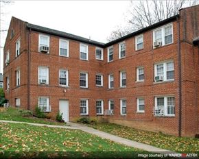 Washington apartment for rent - A red brick building with white windows and a white door.