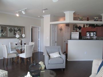 Grand Prairie apartment for rent - A living room with a grey couch and a glass table.