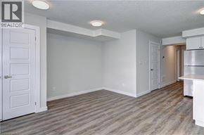 Kitchener townhouse for rent - A realtor logo is on the wall in a white room.