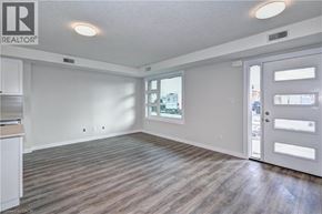 Kitchener townhouse for rent - A spacious room with wooden flooring and a sliding door leading to a balcony.