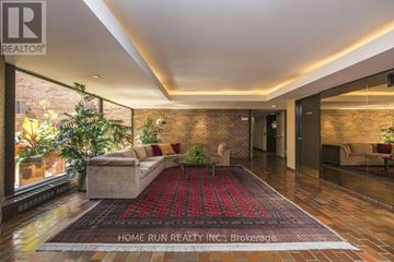 Ottawa condo for rent - A living room with a red carpet and a brick wall.