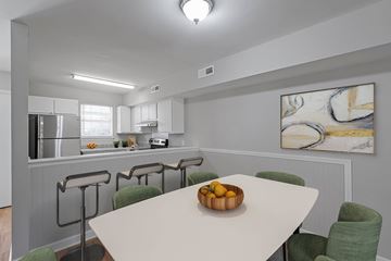 Charleston apartment for rent - A kitchen with a table and chairs in front of a painting.