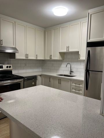 Whitby apartment for rent - A kitchen with a white counter top and stainless steel appliances.