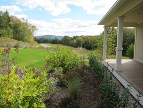 Pittsfield apartment for rent - A view of a green landscape from a porch.