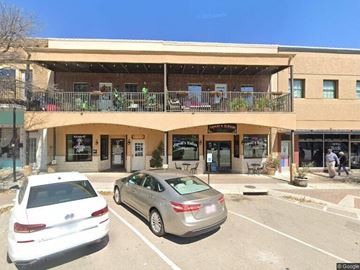 Belton apartment for rent - A white car is parked in front of a building with a sign that says "Honey's".