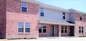Killeen apartment for rent - A red brick house with a grey roof and a white garage door.