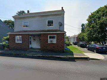 Frackville apartment for rent - A two-story house with a white facade and a brick base.