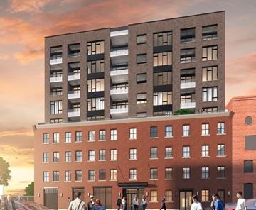 Montreal apartment for rent - A modern building with a red brick facade and a black section on top is depicted with people walking in front.