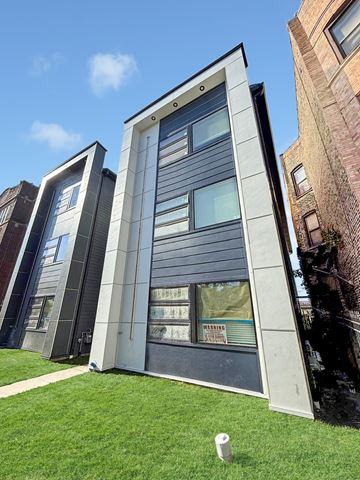 Chicago apartment for rent - A modern house with a grey facade and large windows.