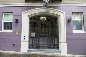 San Francisco apartment for rent - The front of a building with a purple wall and a black gate.