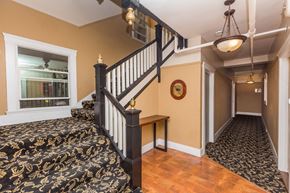 San Francisco apartment for rent - A staircase with a black and gold patterned carpeted stair runner.