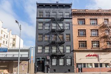 San Francisco apartment for rent - A tall building with a fire escape on the side.