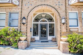 San Francisco apartment for rent - A house with a grey door and a window with a white frame.