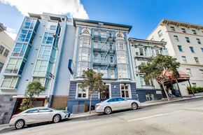 San Francisco apartment for rent - A silver car is parked on the side of a street.