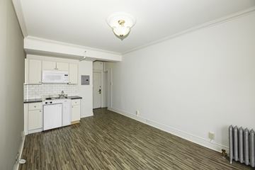 San Francisco apartment for rent - A small kitchen with white cabinets and a white fridge.