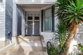San Francisco apartment for rent - A house entrance with a grey door and steps leading up to it.