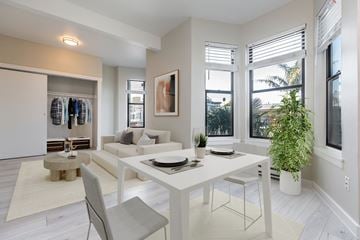 San Francisco apartment for rent - a dining room with a white table and chairs and a living room