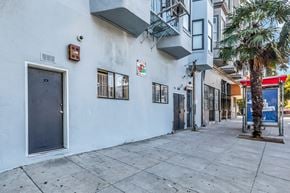 San Francisco apartment for rent - A white building with a black door and windows on the side.