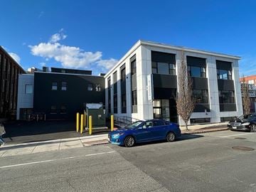 Worcester apartment for rent - A blue car is parked in front of a white building.