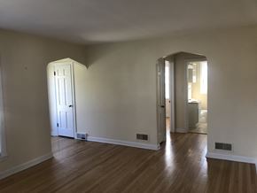 Skokie apartment for rent - A room with a white door and wooden floors.