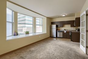 Harrisburg apartment for rent - an empty living room with a kitchen and a large window