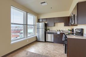 Harrisburg apartment for rent - an empty kitchen with stainless steel appliances and a large window