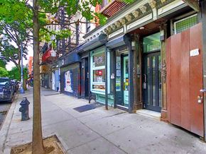 New York apartment for rent - a city street with shops and a fire hydrant