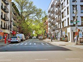 New York apartment for rent - a city street with cars parked on the side of it