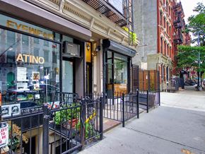 New York apartment for rent - a sidewalk in front of a store on a city street