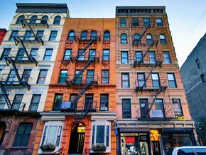 New York apartment for rent - a building with a fire escape on the side of a street