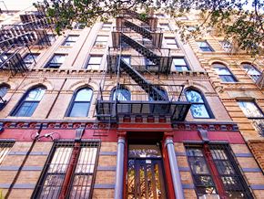 New York apartment for rent - a tall building with a fire escape on the side of it