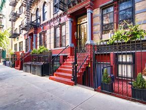 New York apartment for rent - a red staircase in front of a red brick building
