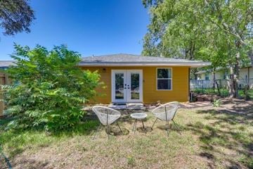 Salado apartment for rent - A yellow house with a white door and two chairs in front.
