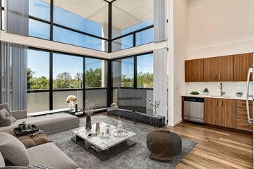 Denver apartment for rent - A modern living room with a glass coffee table and a grey sofa.