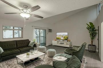 Wheat Ridge apartment for rent - A living room with a green couch and a white coffee table.