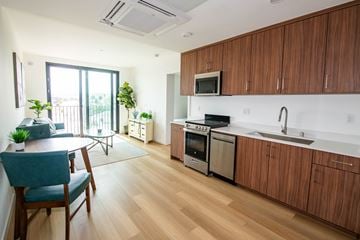 Los Angeles apartment for rent - A kitchen with wooden cabinets and a white countertop.