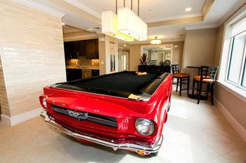 Billiards room with a collector's edition 1965 mustang pool table
