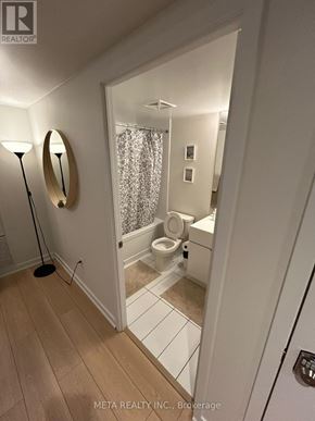 Toronto (Waterfront Communities) condo for rent - A bathroom with a toilet, sink, and mirror.