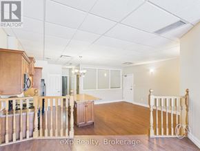 For rent in Kincardine - A room with wooden floors and a staircase leading to another room.