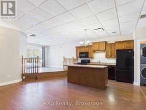 For rent in Kincardine - A washer and dryer are stacked in a small space.