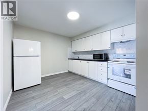 Windsor apartment for rent - A kitchen with white appliances and cabinets.