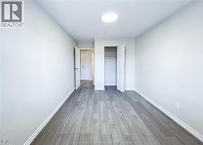 Windsor apartment for rent - A room with wooden flooring and two doors.