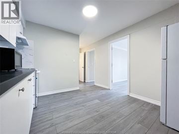 Windsor apartment for rent - A kitchen with white cabinets and a black countertop.