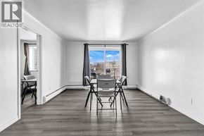Windsor apartment for rent - A room with a table and chairs in front of a window.