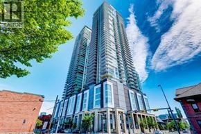 For rent in Calgary - A tall, modern building with many windows is the focal point of the image.
