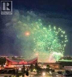 For rent in Calgary - A nighttime cityscape with a large fireworks display.