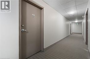 Hamilton apartment for rent - A hallway with a closed door and a carpeted floor.