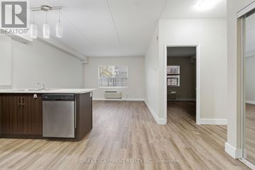 Hamilton (Durand) multi-family for rent - A kitchen with a dishwasher and wooden floors.