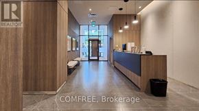 Toronto (Church-Yonge Corridor) condo for rent - A reception area with a wooden wall and a black trash bin.
